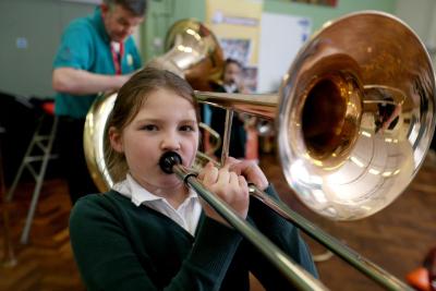 Young girl plays trombone