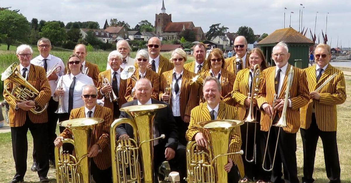 A photo of Bocking Concert Brass assembled  outside with their instruments,