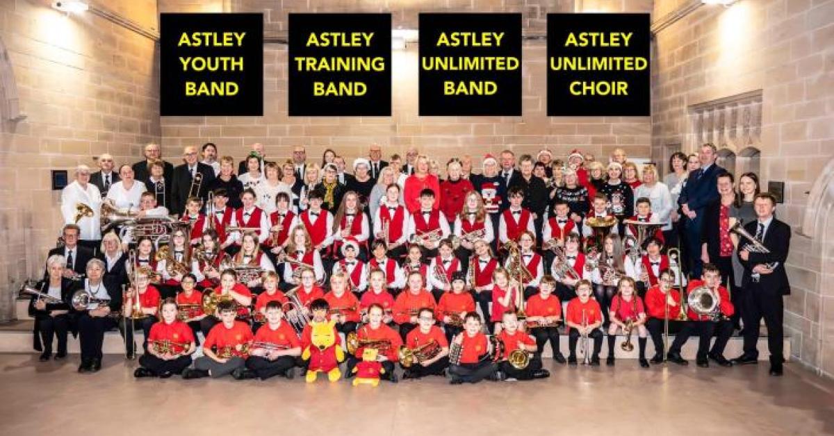 A photo of a large youth band in a school hall.