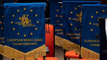 Two blue and gold stand banners with text "European Brass Band Championship"