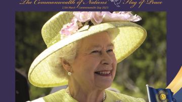 The late Queen takes precedence; she wears a lime green dress with matching hat and smiles. Above her, on a purple background, is written The Commonwealth of Nations Flag of Peace