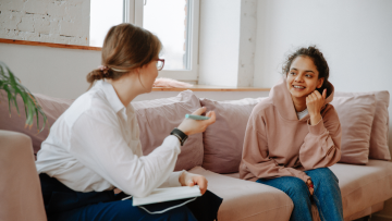 Two young people sit and discuss topics