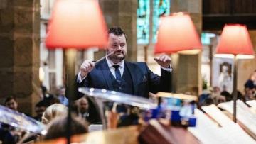 Photo of James Holt conducting a brass band