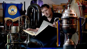 Alex 'Parky' Parker looks over items from the Brass Band Archive