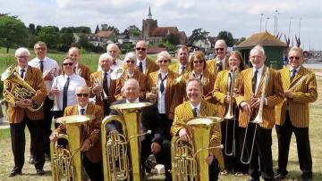 A photo of Bocking Concert Brass assembled  outside with their instruments,