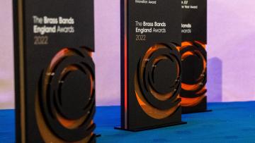 Black and orange awards stand on table with blue tablecloth