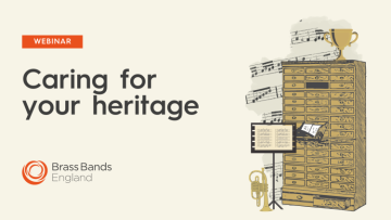 Illustration of a large multi-drawer cabinet with a music stand in front of it and a trophy on top.