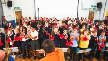 Children playing pbuzz in a school hall