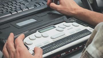 Someone using a Braille typewriter