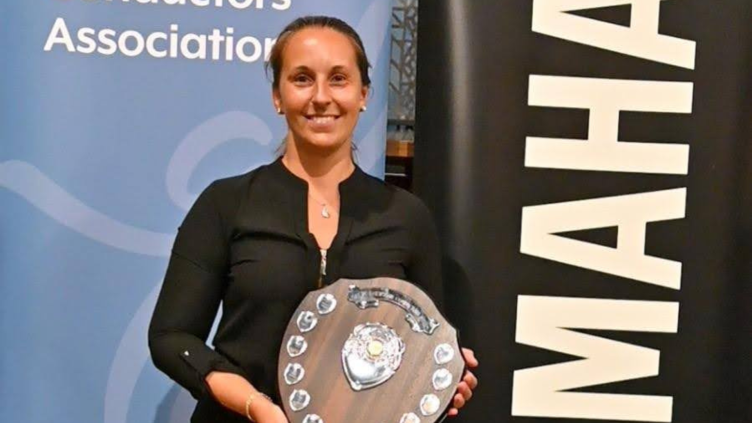 Sara Maganzini holding Shield from BBCA conducting competition