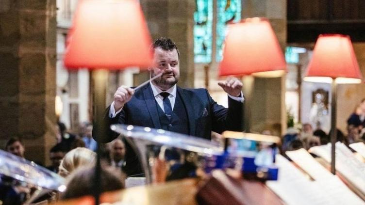 Photo of James Holt conducting a brass band