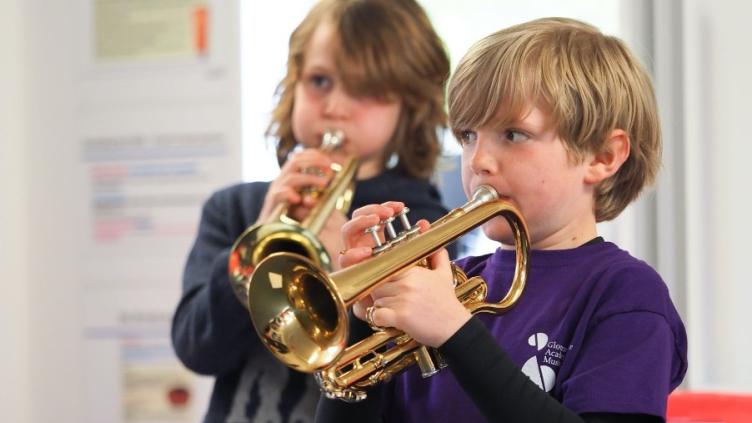 Children playing the cornet in purple t-shirts