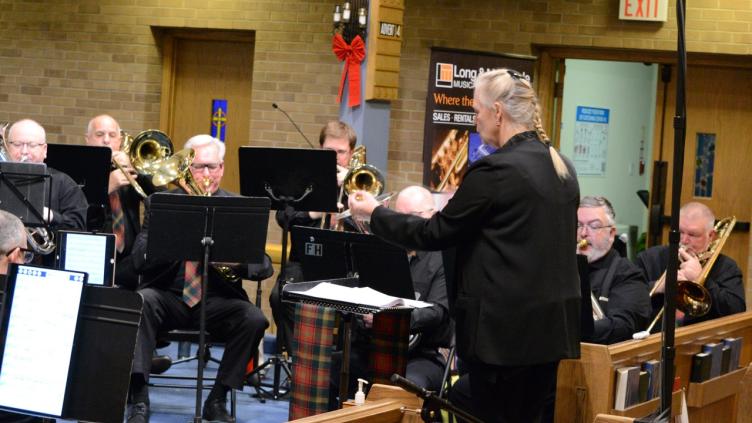 Lady conducting brass band